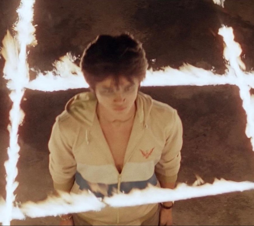 devil fetus header - a young nam stands in the center of a grid of fire