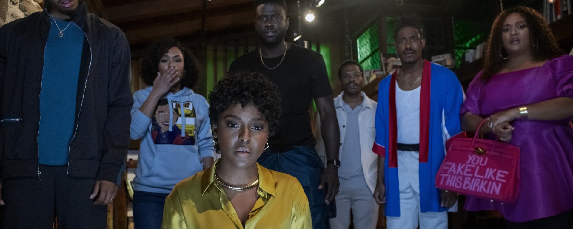 the blackening: the cast stares at the camera, the light of a television lighting their faces