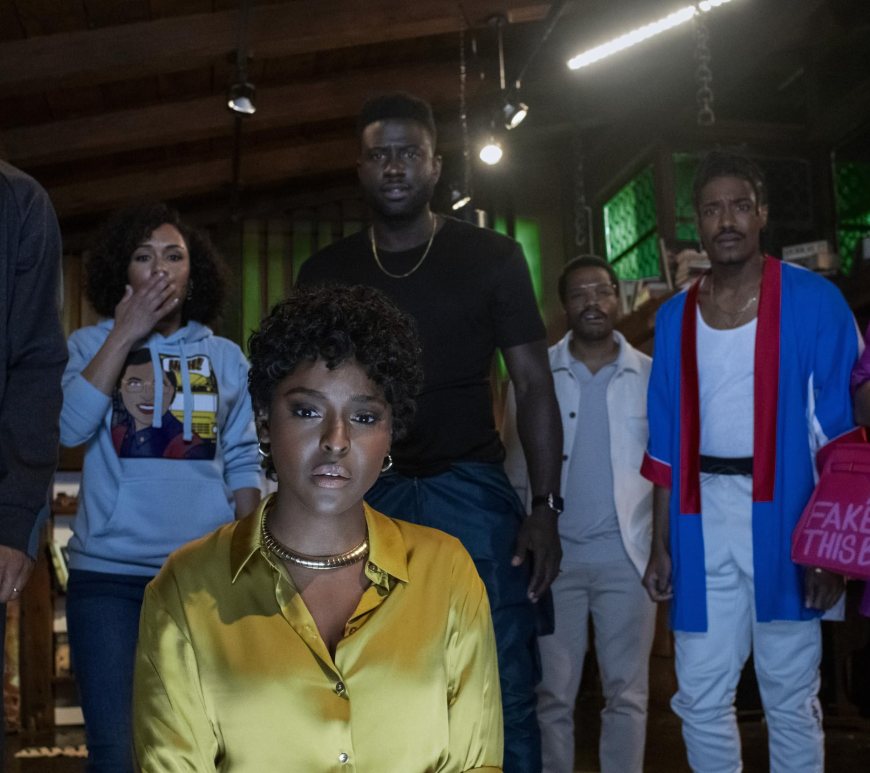 the blackening: the cast stares at the camera, the light of a television lighting their faces