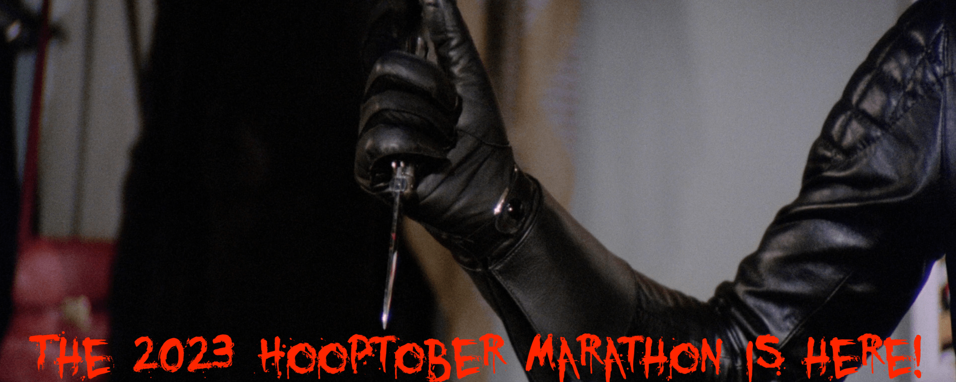 Announcing the 2023 Hooptober kickoff! Bloody letters announce it with a leather gloved hand holding a knife in the background